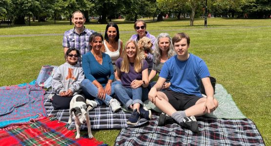 The Safe New Futures team sat on picnic rugs on a team day out